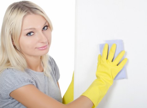 Domestic cleaner tidying a kitchen in a Chiswick property